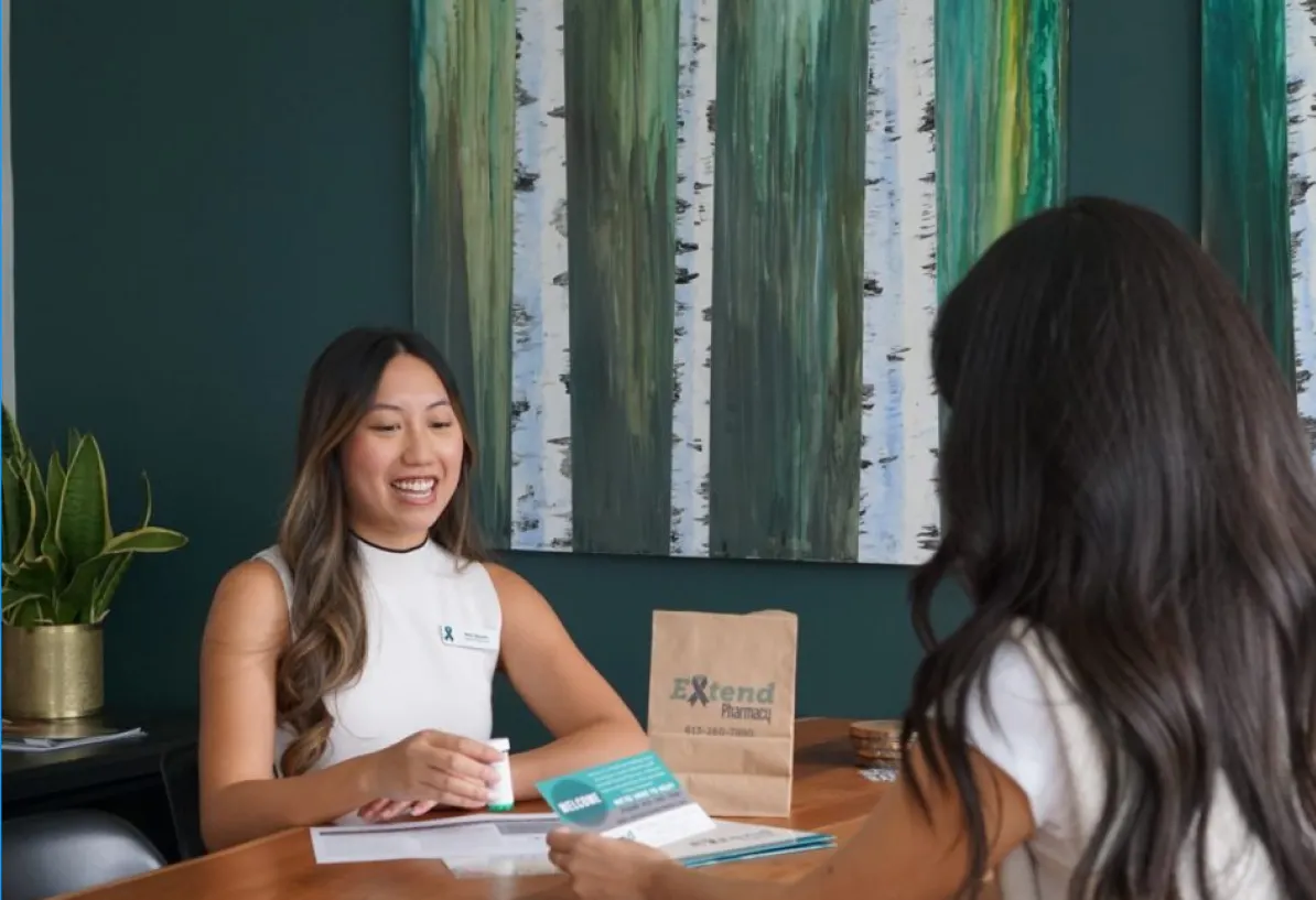 Pharmacy consultation with cancer care information shared across a table
